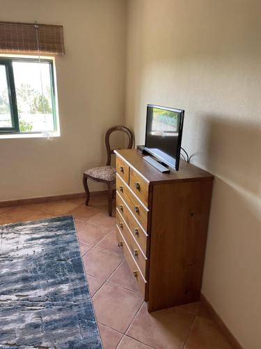 a room with a dresser with a laptop on top of it at Refúgio da Légua in Marco de Canavezes