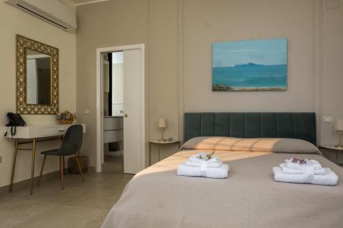 a bedroom with a bed with towels on it at Residenza d’epoca Chiostro San Francesco in Naples