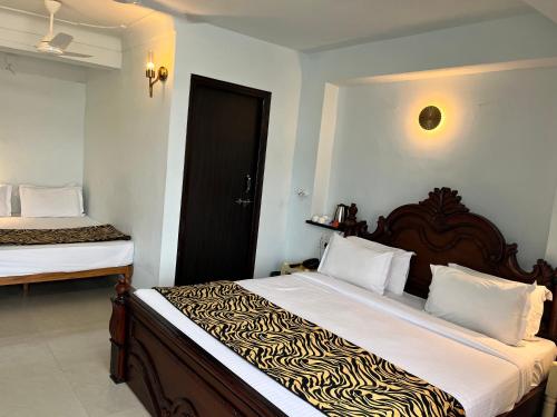 a bedroom with a large bed with a zebra patterned sheets at Hotel The Tiger in Udaipur