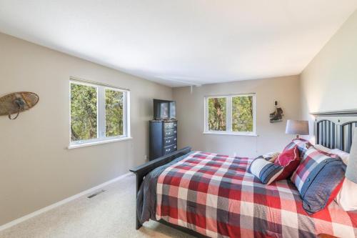 a bedroom with a bed and two windows at 177 Blue Tip Drive in Ridgway