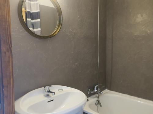 ein Badezimmer mit einem Waschbecken, einem Spiegel und einer Badewanne in der Unterkunft Studio Châtel, 1 pièce, 4 personnes - FR-1-198-237 in Châtel