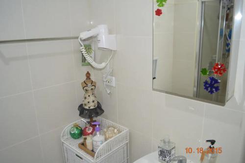 a bathroom with a mirror and a sink at Staycation at Tagaytay 1733 Wind Residences with Taal Lake view WIFI and free parking in Tagaytay