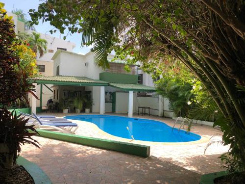 a swimming pool in front of a building at Terrazas del Caribe, Boca Chica. in Boca Chica