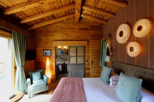 a bedroom with a bed and a chair in a room at La Signoria in Calvi