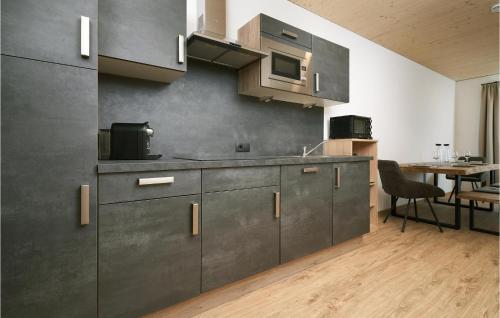 a kitchen with stainless steel cabinets and a table at Sehr Schoene Ferienwohnung in Längenfeld