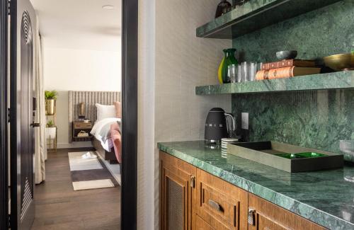 a kitchen with a green counter top and a sink at Orli La Jolla in San Diego