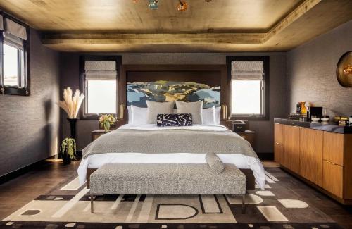 Orli La Jolla في سان دييغو: غرفة نوم بسرير كبير ومقعد فيها