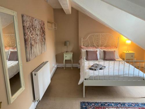 a small bedroom with a bed and a mirror at Villa with Park Views close to Liverpool Centre in Liverpool