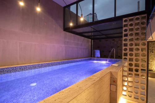 a large swimming pool in a building with an indoor swimming pool at Unique Mine - Luxury Lofts with Pool - Gym - Cowork in Bogotá