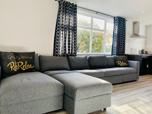 a living room with a couch and a window at The Gathering Sale - Sleeps Up To 22 in Sale