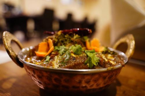 a bowl of food sitting on top of a table at Hotel White Lotus Gangtok in Gangtok