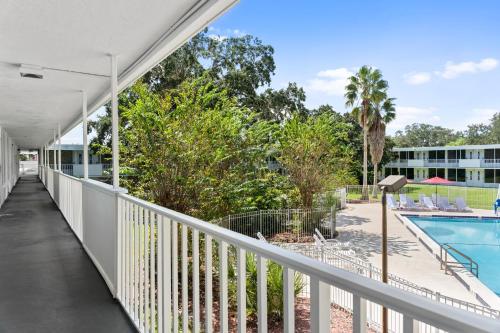 a balcony with a pool and a building at Baymont by Wyndham Orlando Lake Buena Vista South in Kissimmee