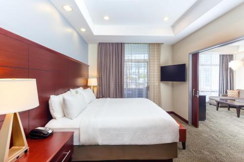 a hotel room with a bed and a television at Staybridge Suites Las Vegas - Stadium District in Las Vegas