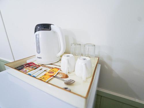 a white appliance sitting on top of a table at RoomQuest Rim Praya Dinsor Road in Bangkok