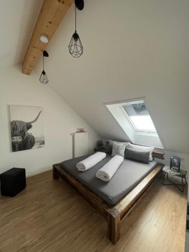 a bedroom with a bed in a attic at BEe HOME - Urlaubs und Business Loft in Kevelaer