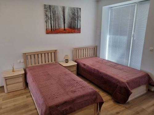 Postel nebo postele na pokoji v ubytování Neris apartments