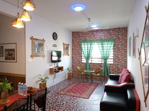 a living room with a couch and a brick wall at Seroja Residence Kuala Terengganu in Kuala Terengganu
