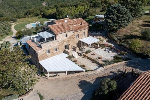 an aerial view of a large brick building with solar panels at Gilda in Roccalbegna