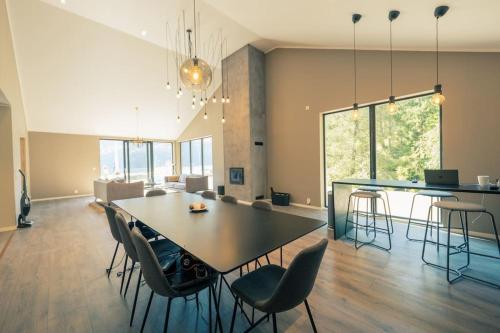 a dining room and living room with a table and chairs at Modalen Fjord Cottage in Mo