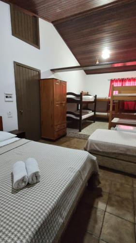 a bedroom with two beds with towels on them at Hotel Pousada Bossa Nova in Maceió