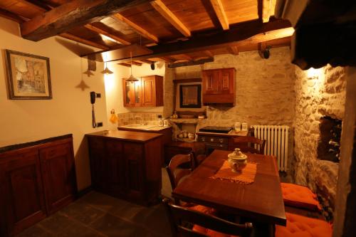a kitchen with a wooden table and a stove top oven at Casina Iannelli in Cortona