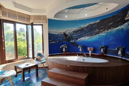 a bathroom with a whale painting on the wall at Mavisu Deluxe Butik Otel in Trabzon