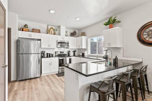 a kitchen with white cabinets and stainless steel appliances at Brand New 2 Bed 2 Bath Near Perry District and DT in Spokane