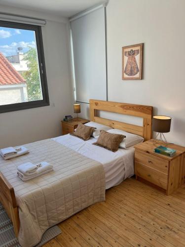 a bedroom with a large bed and a window at Demetra 1 Bdr Down Town Nicosia in Nicosia