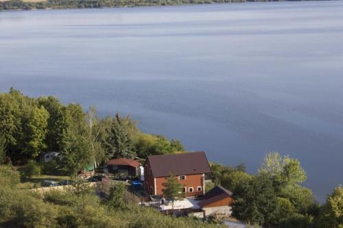 an aerial view of a house and the water at Apartmány u Dlouhána in Kadaň