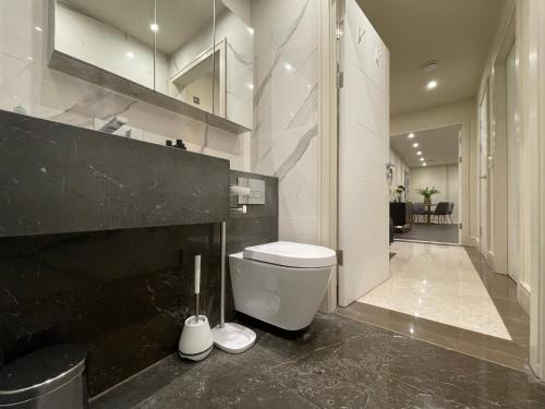 a bathroom with a white toilet and a black counter at High End 1 BR Apt, 2 Beds Desirable Chigwell in Chigwell