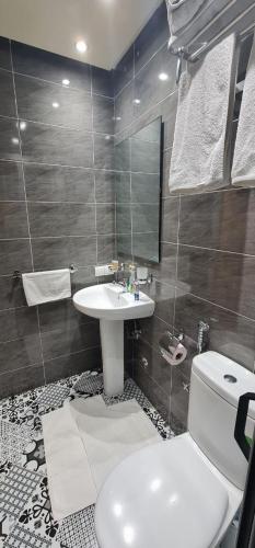a bathroom with a white toilet and a sink at Bonne étoile Imsouane in Imsouane