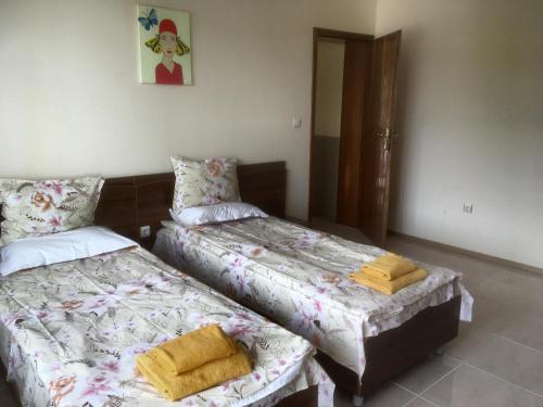 two beds sitting next to each other in a room at Two-Bedroom Apartment with Sea View in Kavarna