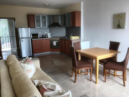 a kitchen with a couch and a table with chairs at Two-Bedroom Apartment with Sea View in Kavarna