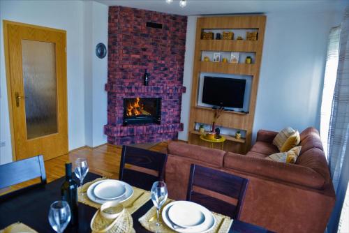 a living room with a couch and a fireplace at Holiday home Maša - Kupres in Kupres