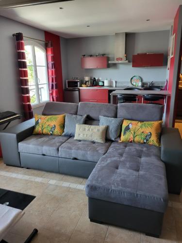 a living room with a couch and a kitchen at La Bastide du Canal in Carcassonne