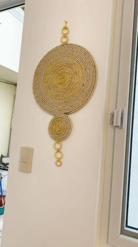 a straw hat hanging on a wall next to a door at Curious Family Space D1 in Guatemala