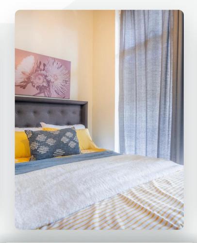a bedroom with a bed and a window at Batchelor City Studio Apartment in Durban