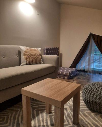 a living room with a couch and a table at Вила Bora Vista 1 in Tsigov Chark