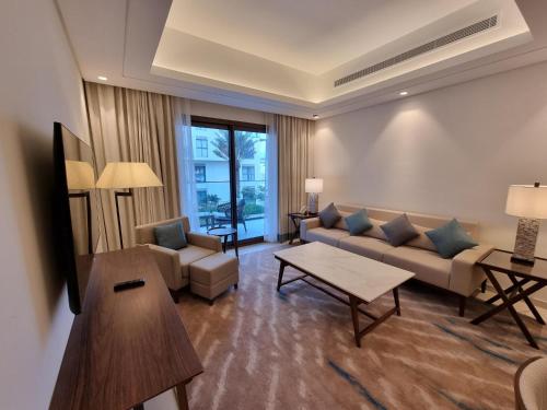 a living room with a couch and a table at Shaqa at Address Beach Residence - Fuj in Fujairah