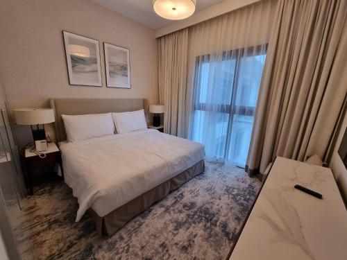 um quarto de hotel com uma cama e uma grande janela em Shaqa at Address Beach Residence - Fuj em Fujairah