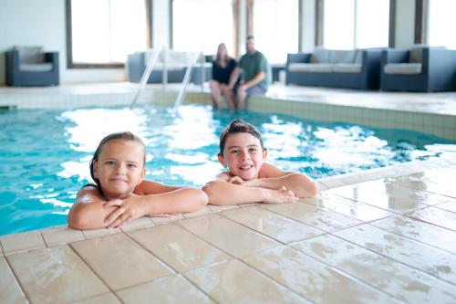 two children laying in a swimming pool at Rodd Miramichi in Miramichi