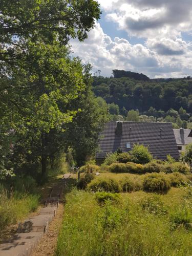 a view of a garden with two buildings at Ferienwohnung Jansen in Kirchhundem