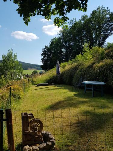 a picnic table and a bench in a field at Ferienwohnung Jansen in Kirchhundem