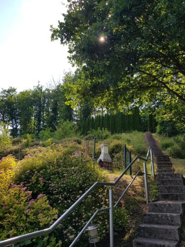 a set of stairs in a garden with flowers at Ferienwohnung Jansen in Kirchhundem