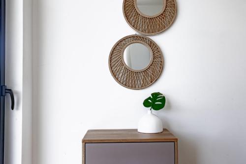 two mirrors on a wall above a table with a plant at Ocean view luxury Villa, Private Pool 4BD 8PPL in Playa Venao