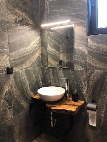 a bathroom with a white sink and a mirror at Вила Bora Vista 2 in Tsigov Chark