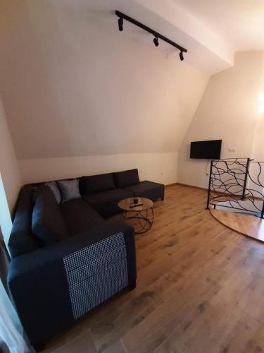 a living room with a couch and a flat screen tv at Вила Bora Vista 2 in Tsigov Chark