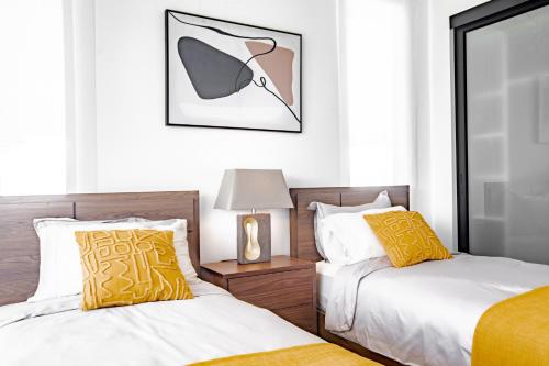 two beds sitting next to each other in a bedroom at Ocean view luxury Villa, Private Pool 4BD 8PPL in Playa Venao