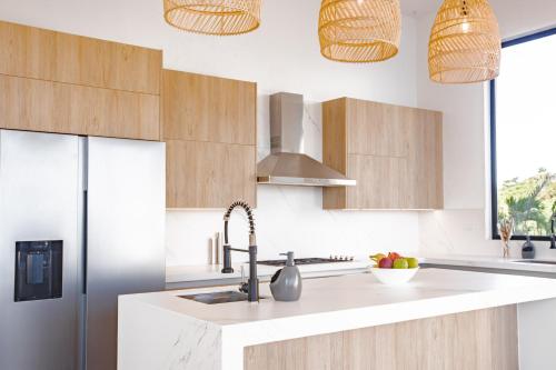 a kitchen with a sink and a refrigerator at Ocean view luxury Villa, Private Pool 4BD 8PPL in Playa Venao