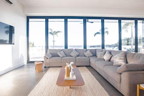 a living room with a couch and a table at Ocean view luxury Villa, Private Pool 4BD 8PPL in Playa Venao